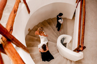 Beachfront wedding ceremony under floral arch, Tulum